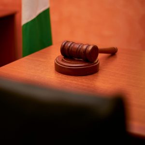 A close-up of a gavel on a courtroom desk representing law and justice.